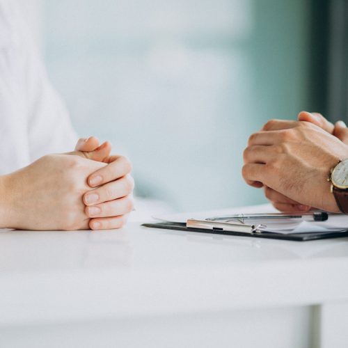 Physician consulting his patient at clinic